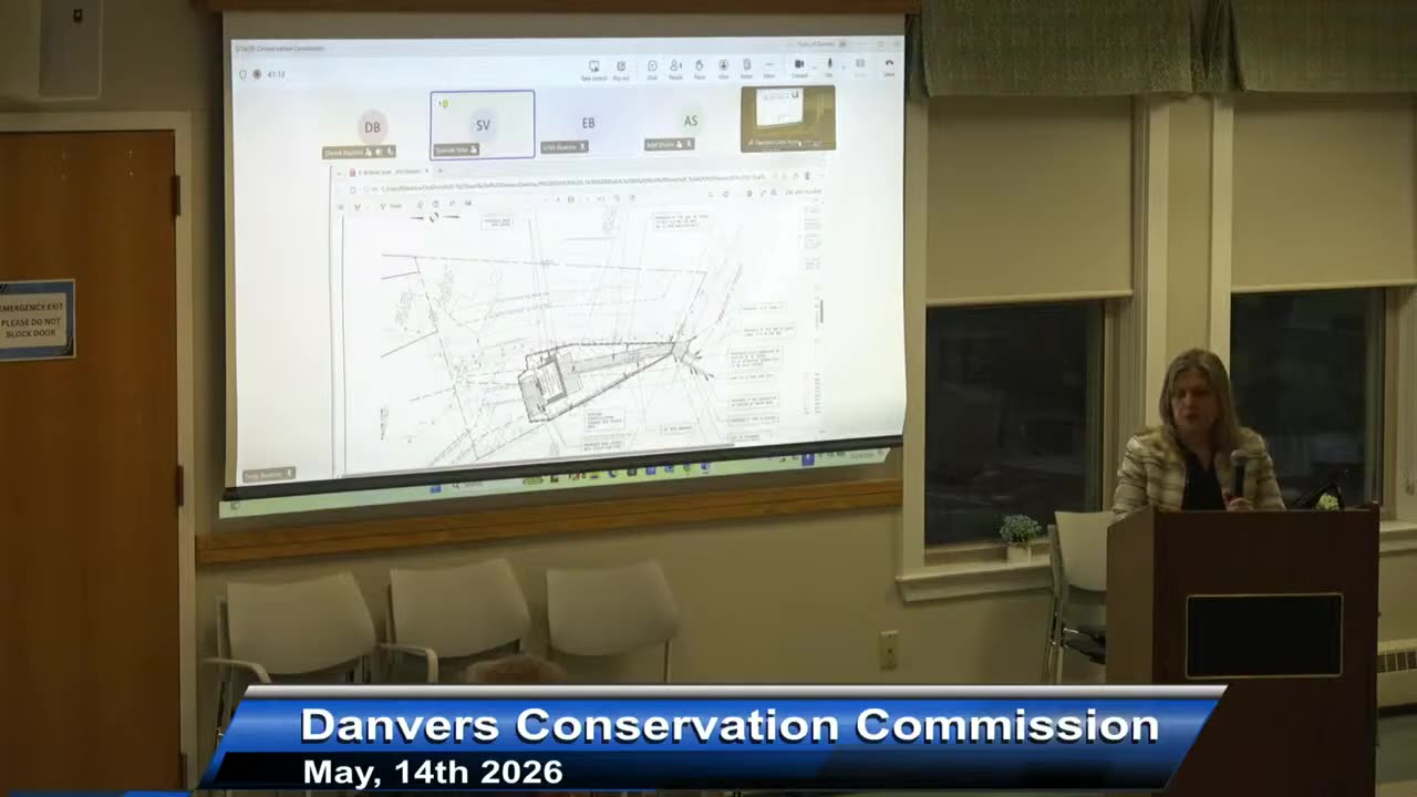 Large projection of annotated site plan on screen