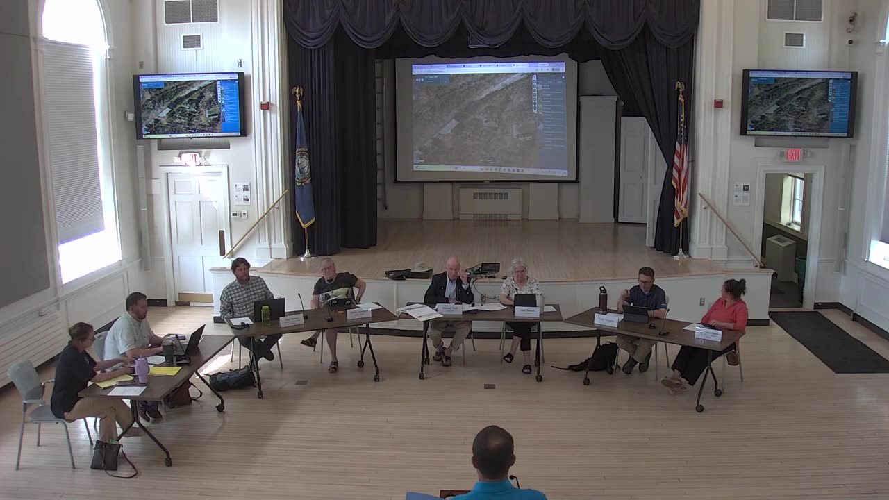 Aerial site maps displayed on projector and side screens